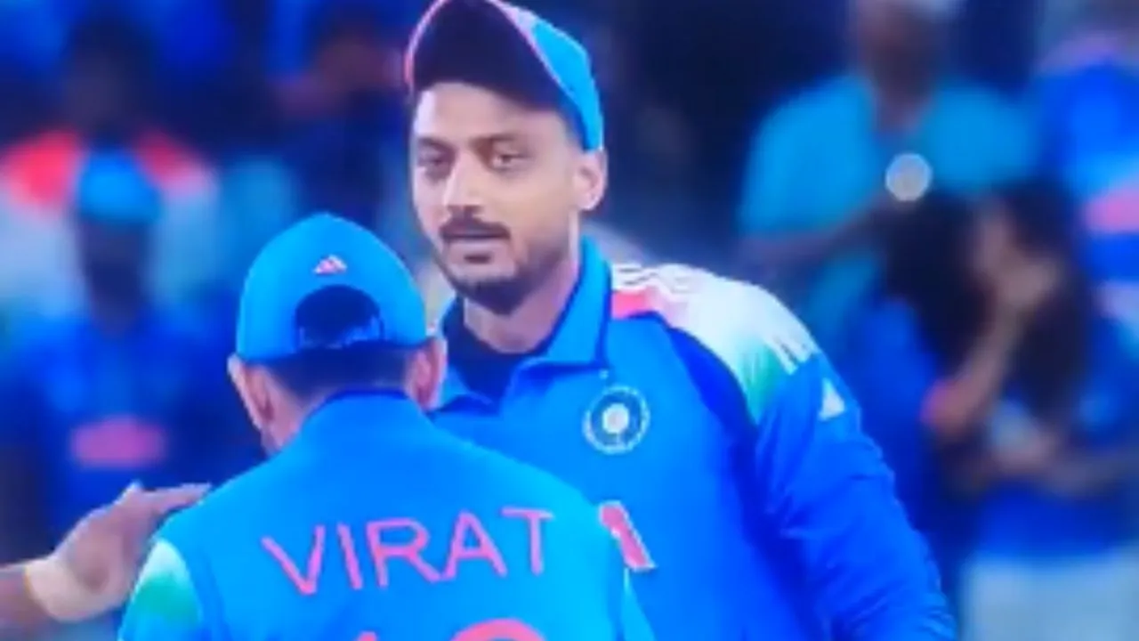 Virat Kohli touching Axar Patel's feet .webp